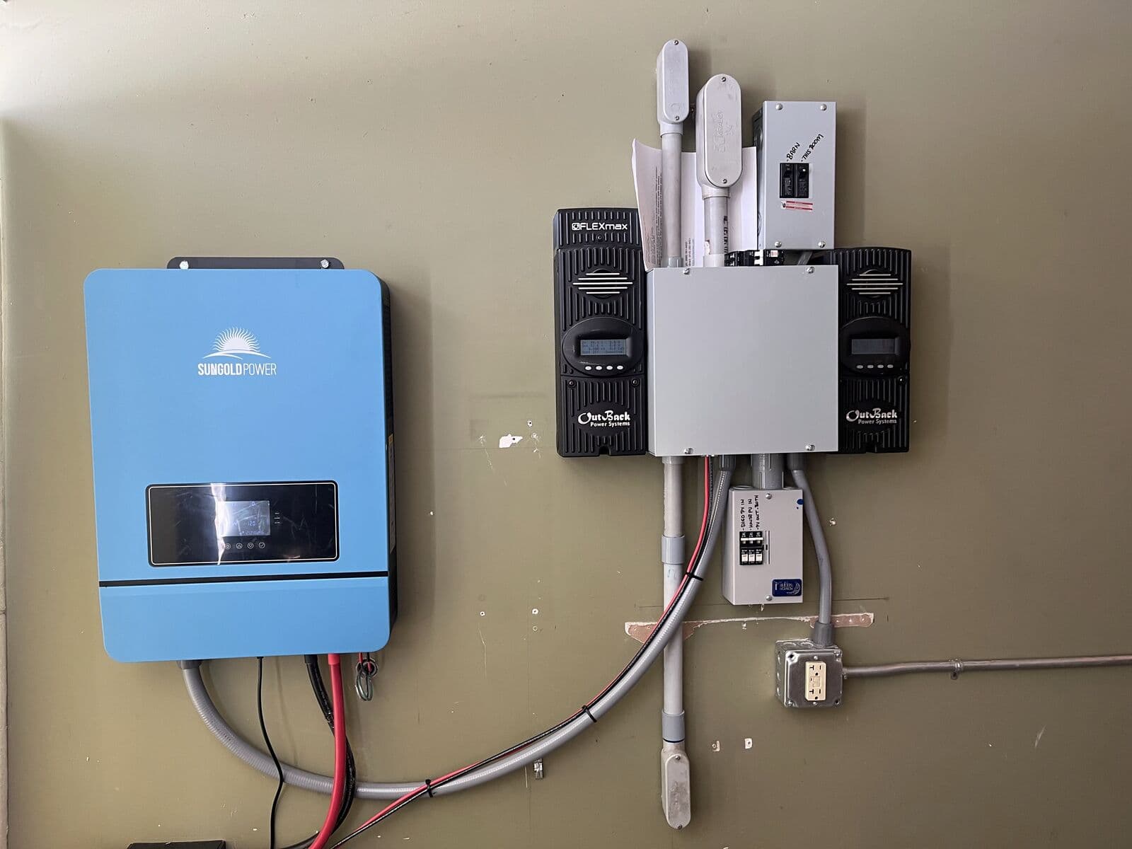 Solar hybrid inverter and charge controllers on a wall