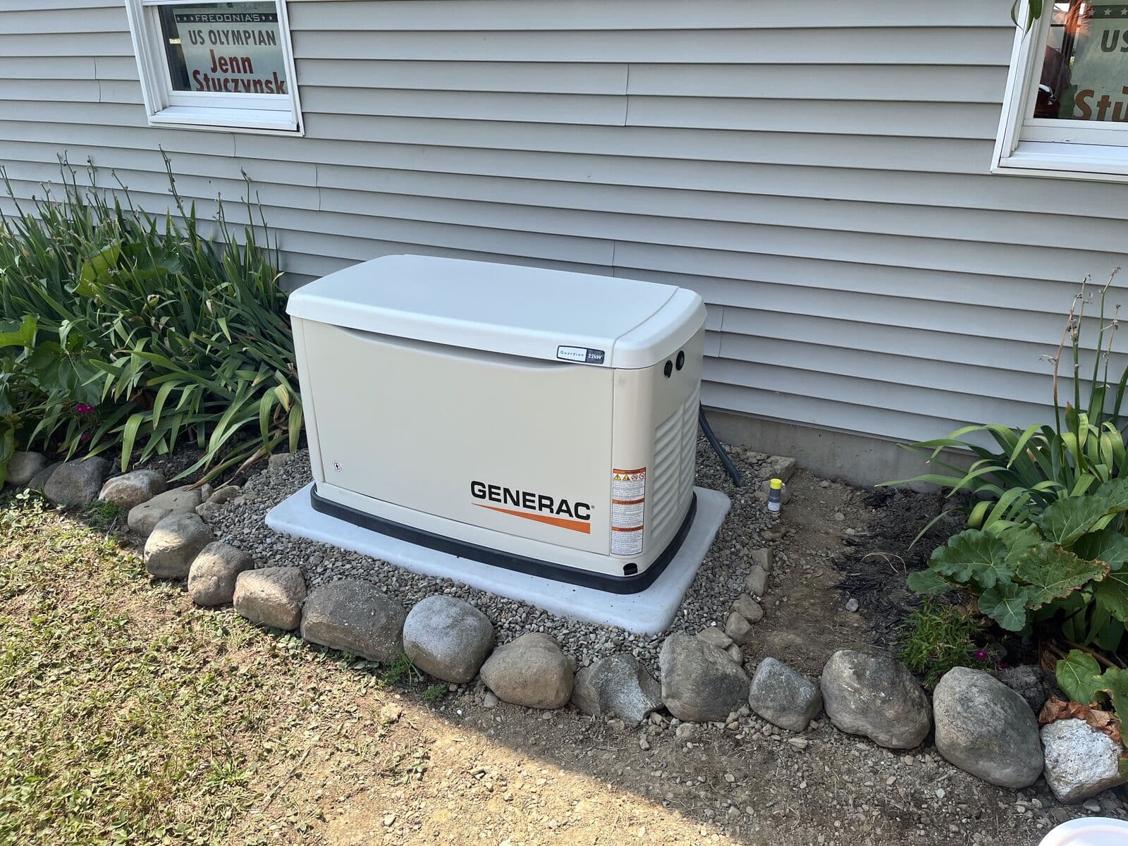 Generac standby generator installed beside a home